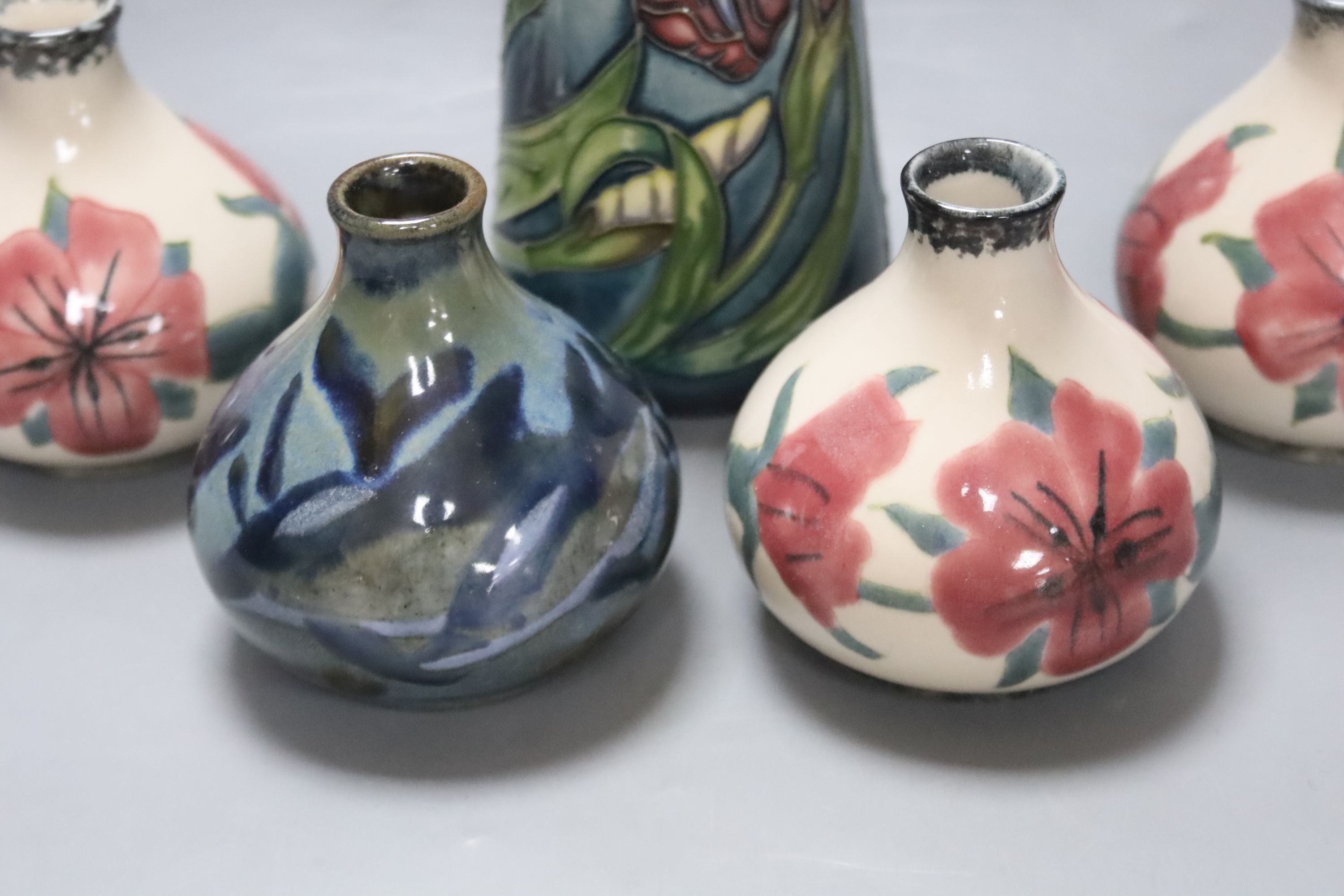 A Moorcroft iris pattern jug and two anenome dishes, together with four Cobridge vases